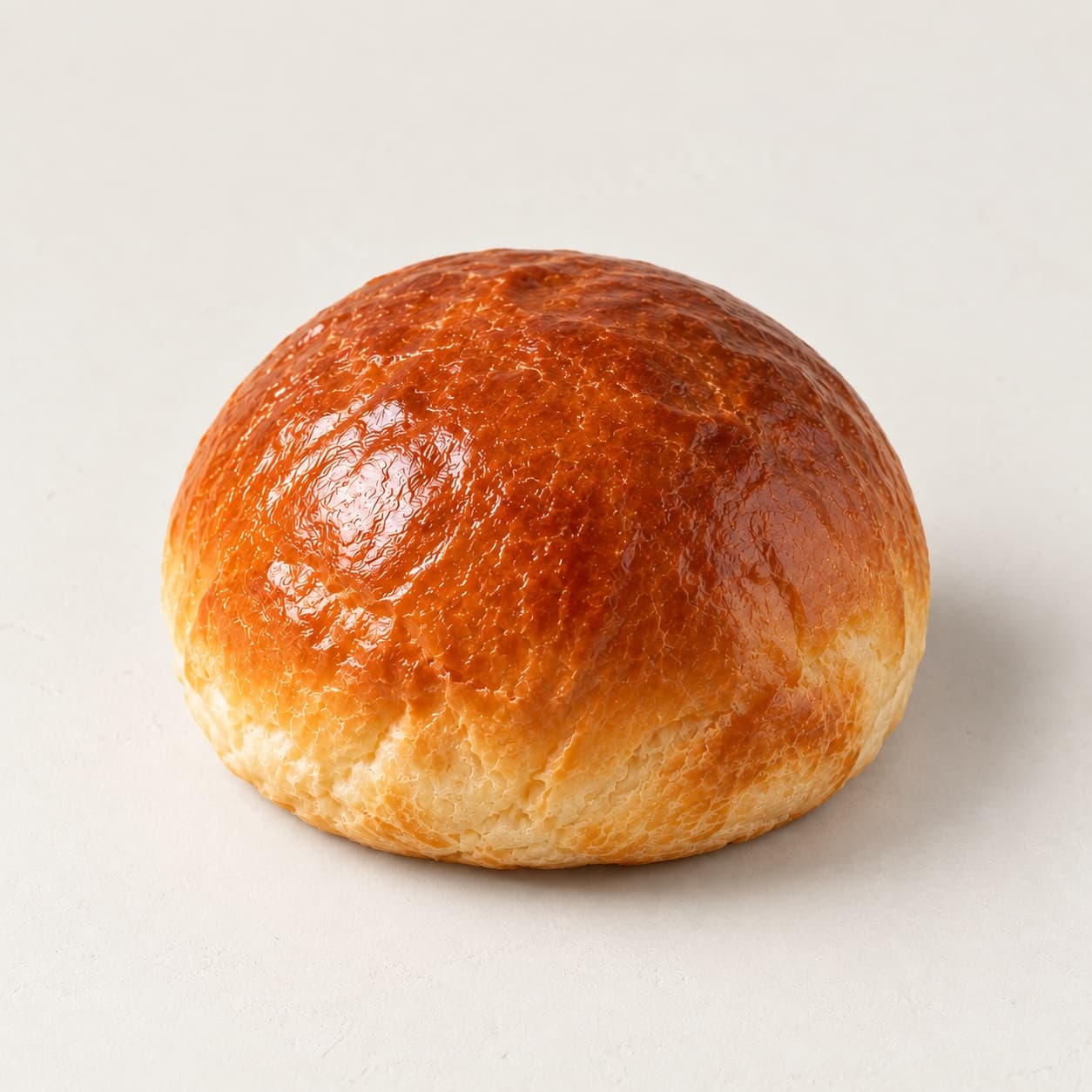 A golden brioche bun, one of the doughs for bōm dough breakfast sandwiches in Cambridge, MA.